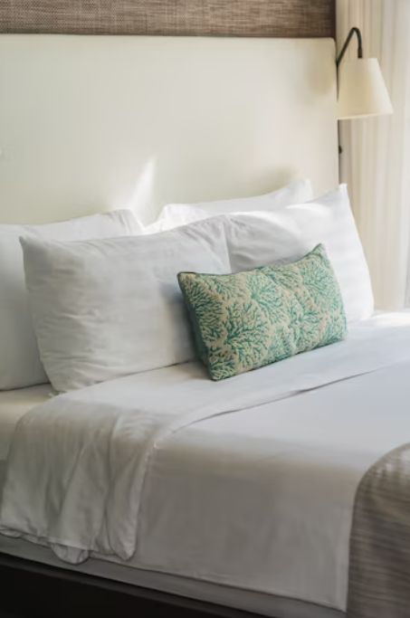 hotel room white bed and sheets